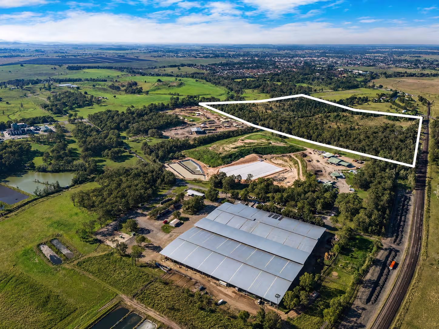 Wide aerial view of the Northern Rivers Intermodal rail freight industrial estate near Casino NSW with site boundary marked.