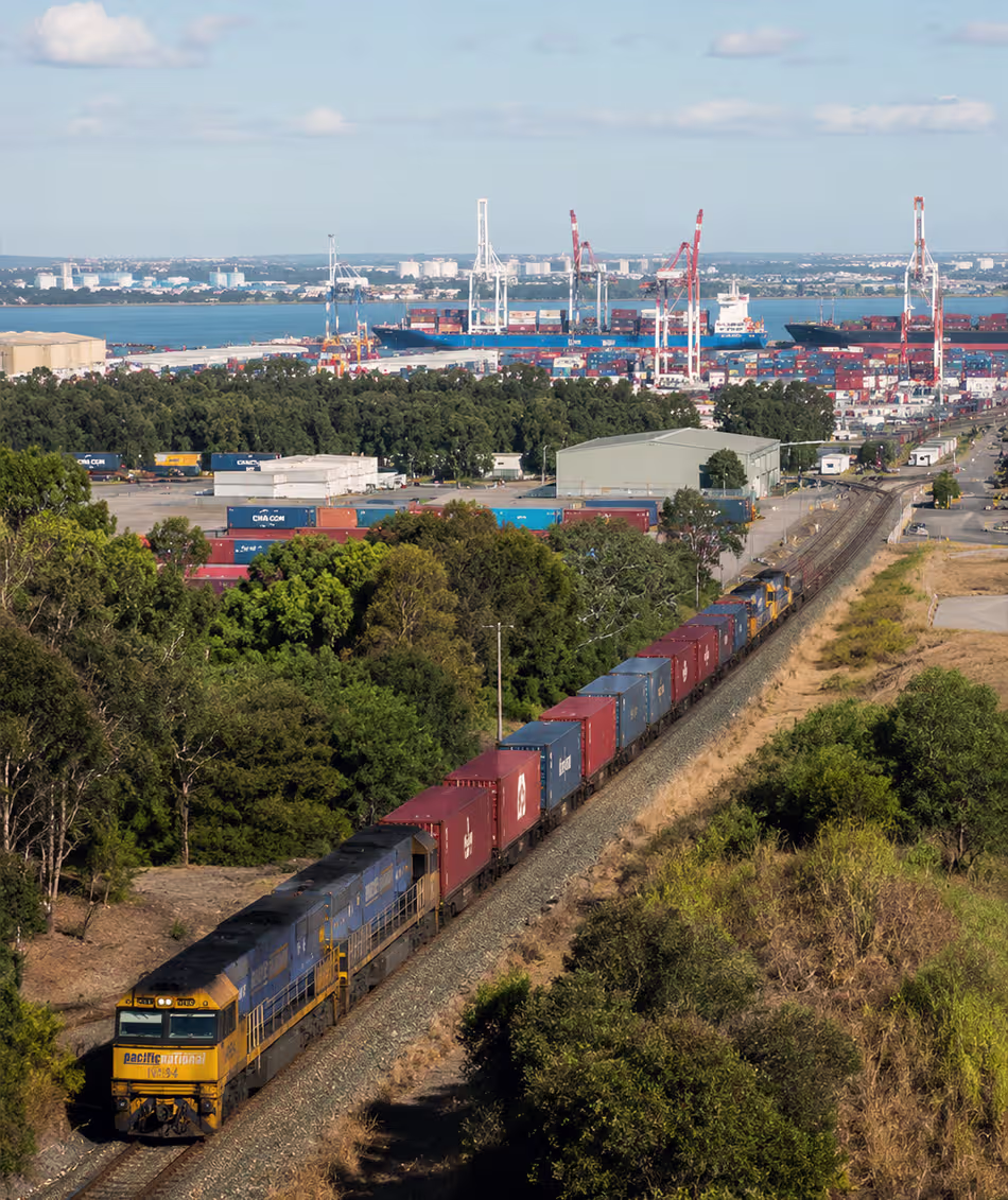 Artist impression of an intermodal freight train transporting shipping containers through a logistics corridor connected to a major port terminal in Queensland.